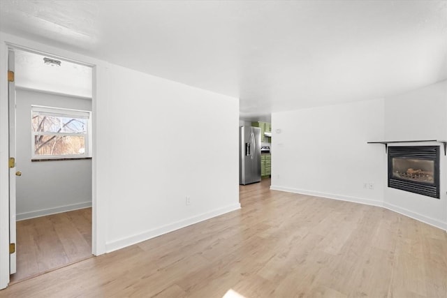 unfurnished living room with light hardwood / wood-style flooring