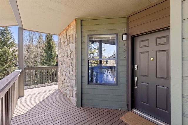 doorway to property featuring stone siding