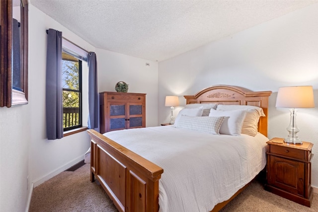 bedroom featuring light carpet, a textured ceiling, and baseboards