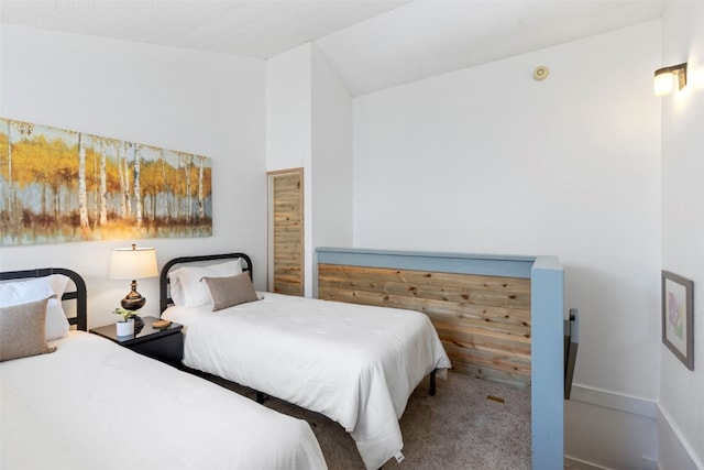 carpeted bedroom with lofted ceiling