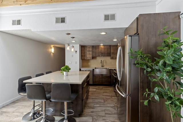 kitchen with stainless steel appliances, visible vents, and a sink