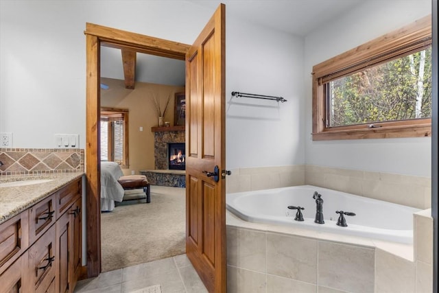 2137 Overlook Ln Unit 104, Steamboat Springs, CO 80487 - full bathroom with healthy amount of natural light, ensuite bathroom, a fireplace, and a bath