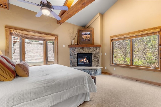 2137 Overlook Ln Unit 104, Steamboat Springs, CO 80487 - bedroom featuring multiple windows, carpet floors, a stone fireplace, and a ceiling fan