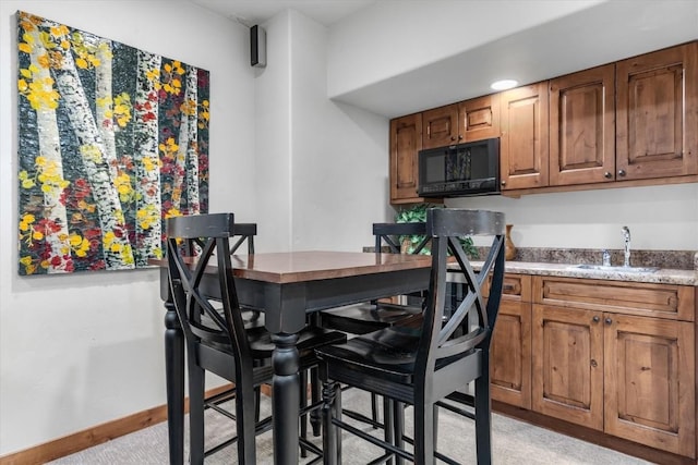2137 Overlook Ln Unit 104, Steamboat Springs, CO 80487 - dining area with bar with sink and light carpet