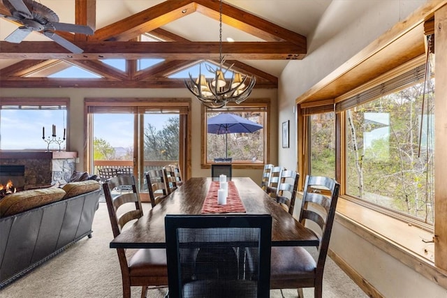 2137 Overlook Ln Unit 104, Steamboat Springs, CO 80487 - dining space with carpet, a glass covered fireplace, healthy amount of natural light, and a chandelier