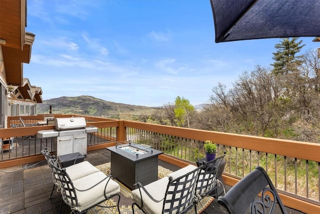 2137 Overlook Ln Unit 104, Steamboat Springs, CO 80487 - wooden deck featuring a mountain view, a fire pit, and a grill