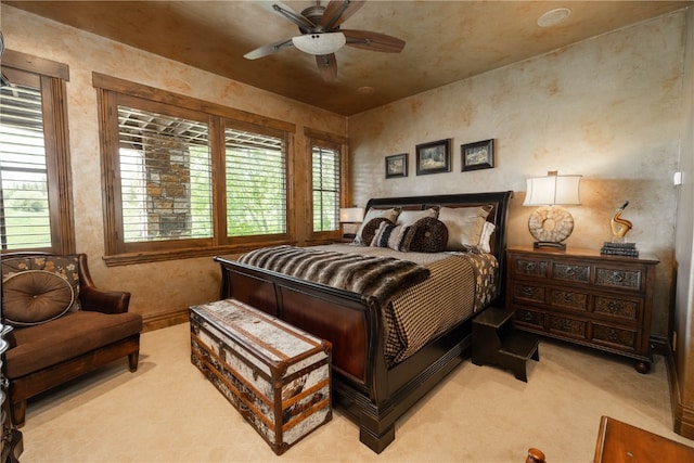 bedroom with light carpet and ceiling fan