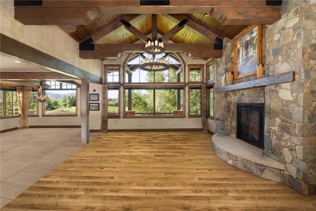 unfurnished living room featuring wooden ceiling, a fireplace, and beamed ceiling