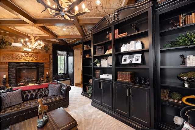 sitting room with a chandelier, coffered ceiling, beam ceiling, and a stone fireplace