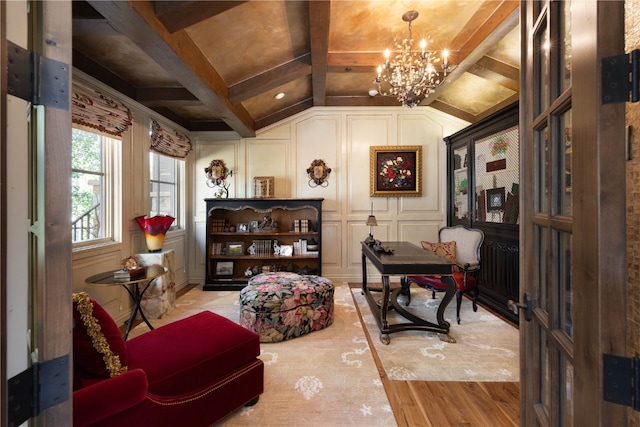 living area with vaulted ceiling with beams, an inviting chandelier, wood finished floors, and a decorative wall