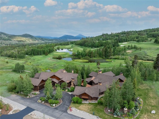 birds eye view of property with golf course view and a water and mountain view