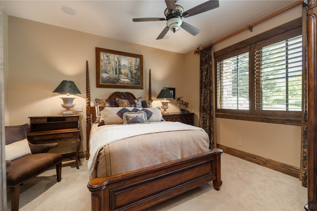 bedroom with light carpet, ceiling fan, and baseboards