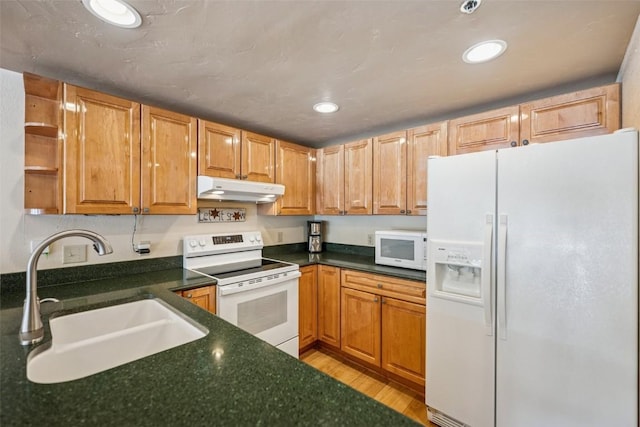 kitchen with open shelves, dark countertops, a sink, white appliances, and under cabinet range hood