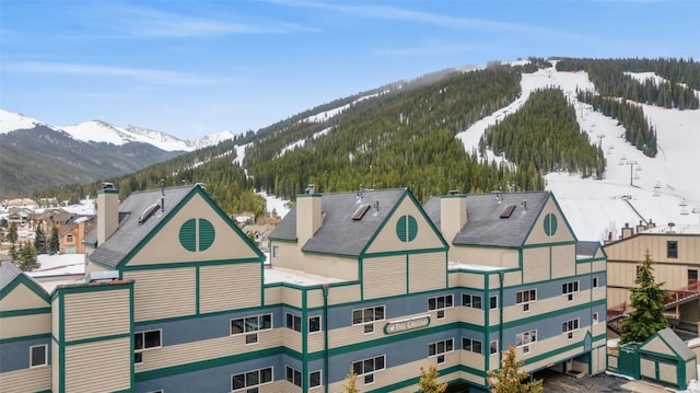 snowy aerial view with a mountain view
