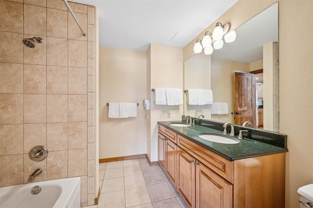 full bath with double vanity, a sink, tile patterned floors, and shower / washtub combination