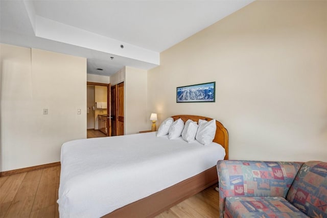 bedroom with baseboards and wood-type flooring