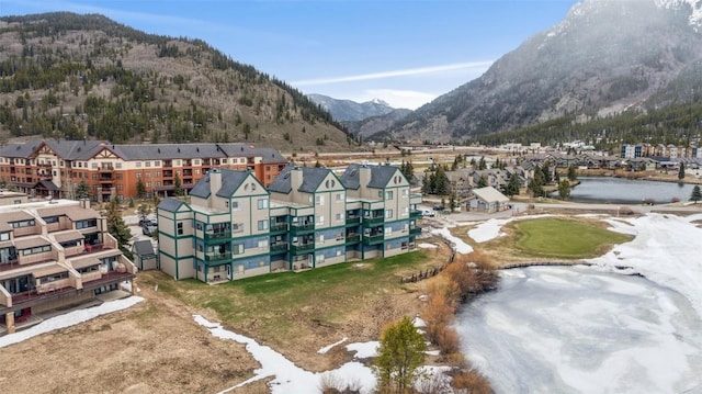 birds eye view of property featuring a water and mountain view