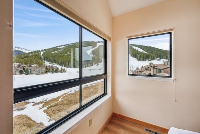 unfurnished sunroom featuring visible vents and a mountain view