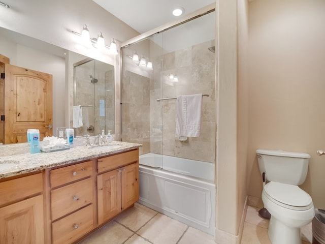 full bathroom with a sink, double vanity, toilet, tile patterned flooring, and enclosed tub / shower combo