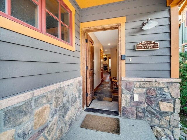 view of exterior entry featuring stone siding