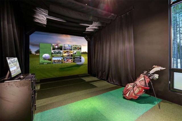 game room with plenty of natural light, carpet flooring, and golf simulator