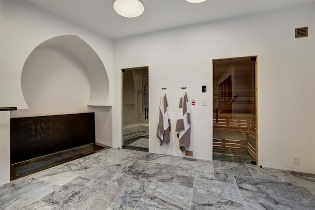 hall with visible vents and marble finish floor