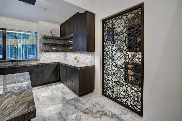 kitchen featuring marble finish floor, open shelves, modern cabinets, dark brown cabinetry, and tasteful backsplash