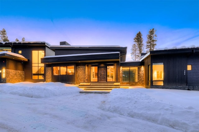 contemporary house featuring stone siding