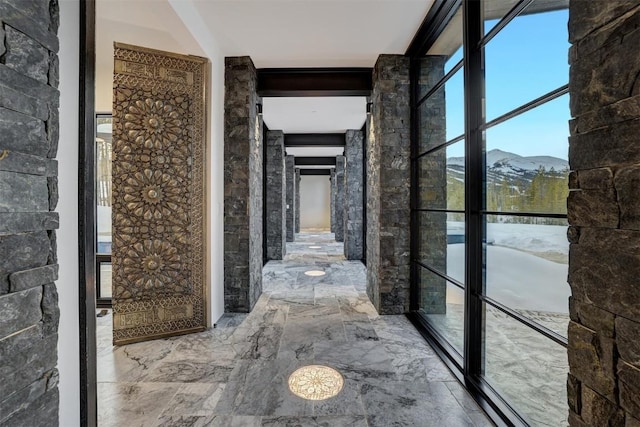 hallway with a mountain view and marble finish floor