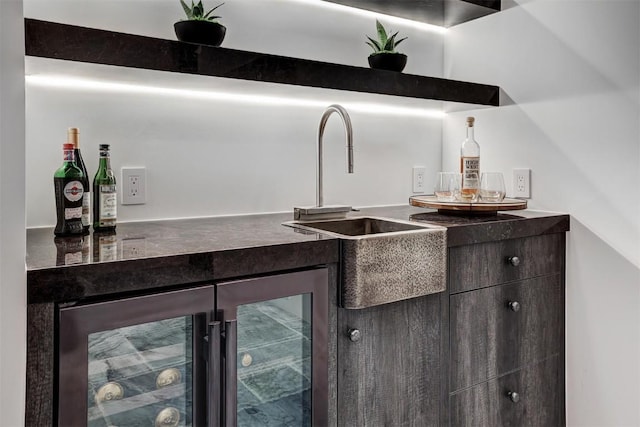 bar with beverage cooler, a dry bar, and a sink