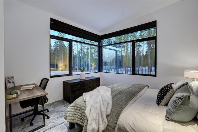 bedroom featuring marble finish floor and multiple windows