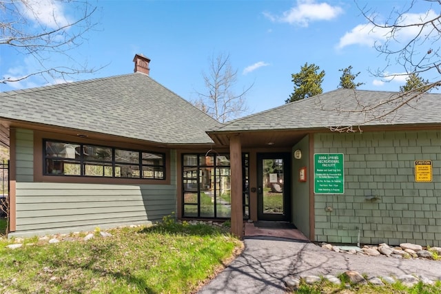 502 Northstar Dr Unit 1947, Keystone, CO 80435 - view of exterior entry with a shingled roof and a chimney