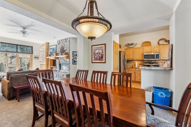 502 Northstar Dr Unit 1947, Keystone, CO 80435 - dining room with a ceiling fan, light carpet, and a fireplace
