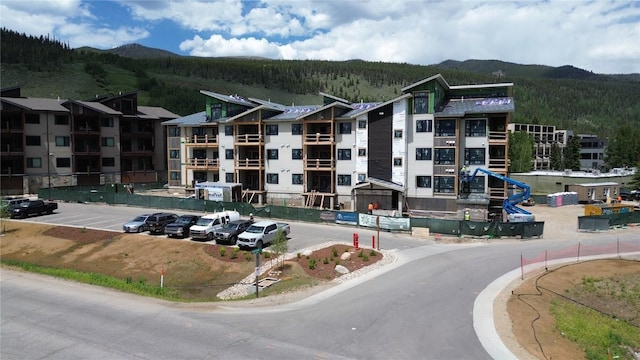 35 Argentine Ct Unit 307, Keystone, CO 80435 - view of building exterior featuring a forest view, uncovered parking, and a mountain view