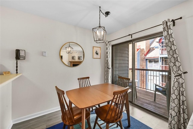 100 S Park Ave Unit E312, Breckenridge, CO 80424 - dining room featuring wood finished floors, a chandelier, and baseboards