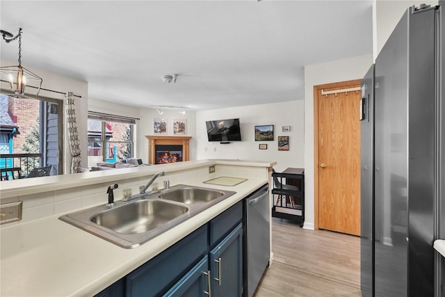 100 S Park Ave Unit E312, Breckenridge, CO 80424 - kitchen with stainless steel appliances, a sink, open floor plan, light countertops, and light wood finished floors
