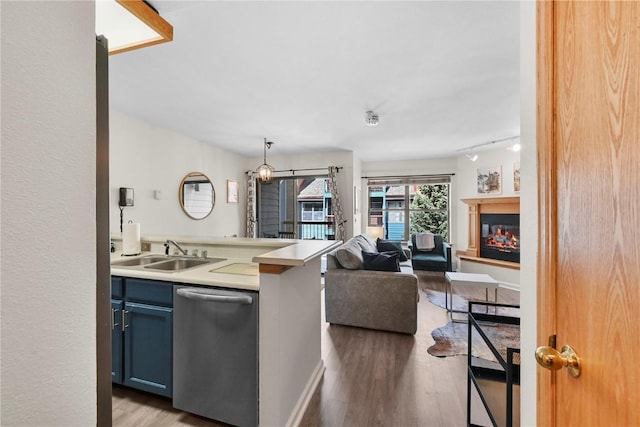 100 S Park Ave Unit E312, Breckenridge, CO 80424 - kitchen featuring dishwasher, a sink, open floor plan, light wood-style flooring, and light countertops