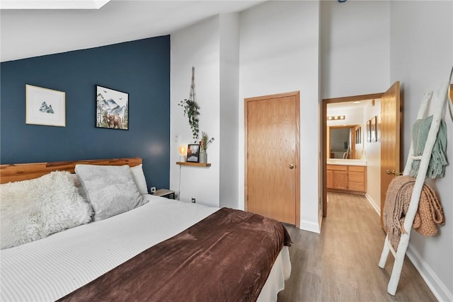 100 S Park Ave Unit E312, Breckenridge, CO 80424 - bedroom featuring high vaulted ceiling, light wood-type flooring, and baseboards