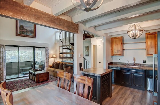 3020 Village Dr Unit 222, Steamboat Springs, CO 80487 - kitchen featuring black dishwasher, dark countertops, dark wood-type flooring, a chandelier, and open floor plan