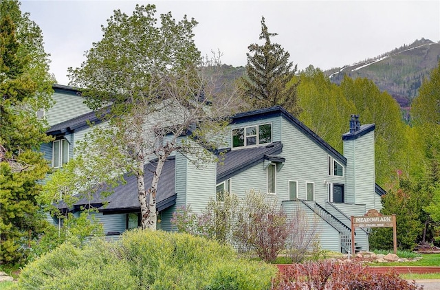 3020 Village Dr Unit 222, Steamboat Springs, CO 80487 - view of side of property featuring a chimney and a mountain view