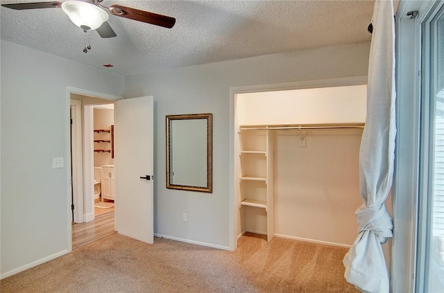 3020 Village Dr Unit 222, Steamboat Springs, CO 80487 - unfurnished bedroom featuring carpet flooring, a textured ceiling, a closet, and a ceiling fan