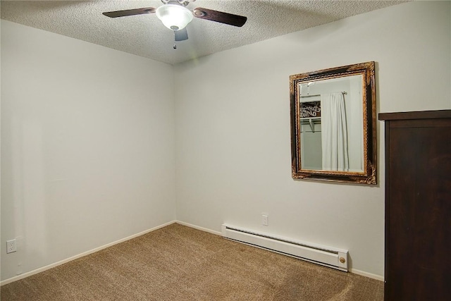 3020 Village Dr Unit 222, Steamboat Springs, CO 80487 - carpeted spare room featuring a baseboard heating unit, a textured ceiling, and a ceiling fan