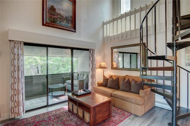 3020 Village Dr Unit 222, Steamboat Springs, CO 80487 - living room featuring stairway, a high ceiling, and wood finished floors