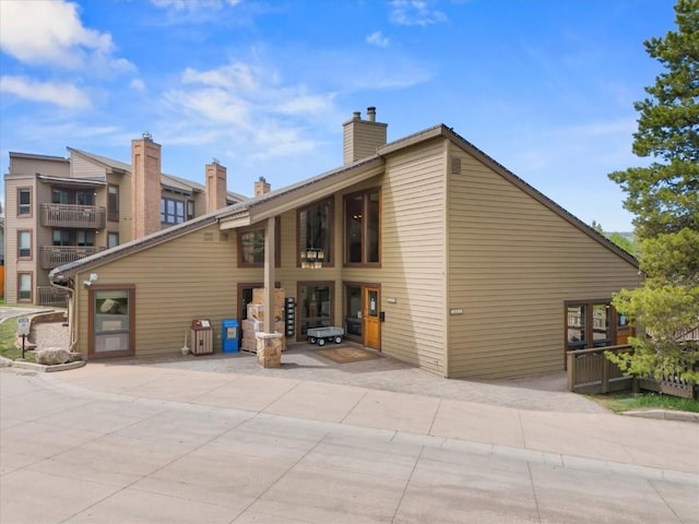 2700 Village Dr Unit 301, Steamboat Springs, CO 80487 - back of property with a patio and a chimney