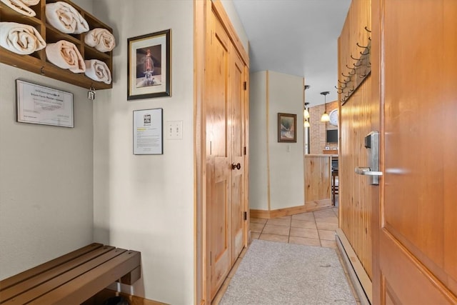 2700 Village Dr Unit 301, Steamboat Springs, CO 80487 - hallway with baseboard heating, light tile patterned floors, and baseboards