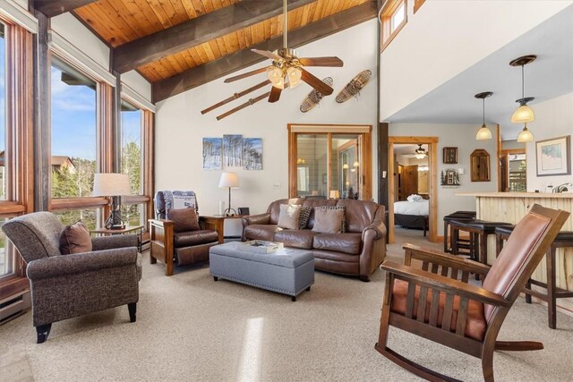 2700 Village Dr Unit 301, Steamboat Springs, CO 80487 - living area featuring plenty of natural light, a ceiling fan, light carpet, beam ceiling, and wood ceiling