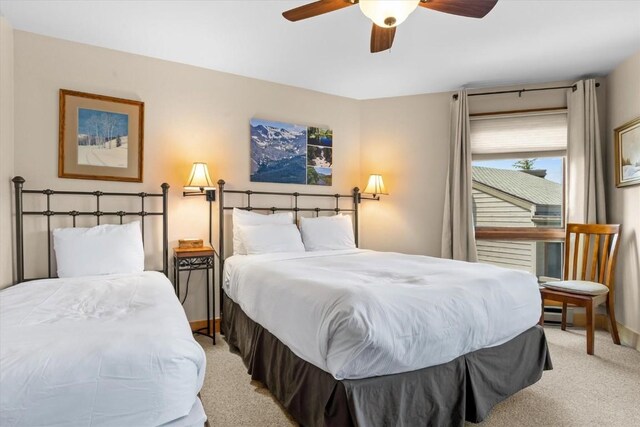 2700 Village Dr Unit 301, Steamboat Springs, CO 80487 - bedroom featuring light carpet and a ceiling fan