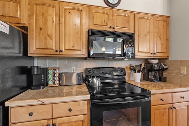 2700 Village Dr Unit 301, Steamboat Springs, CO 80487 - kitchen with black appliances, decorative backsplash, and tile countertops