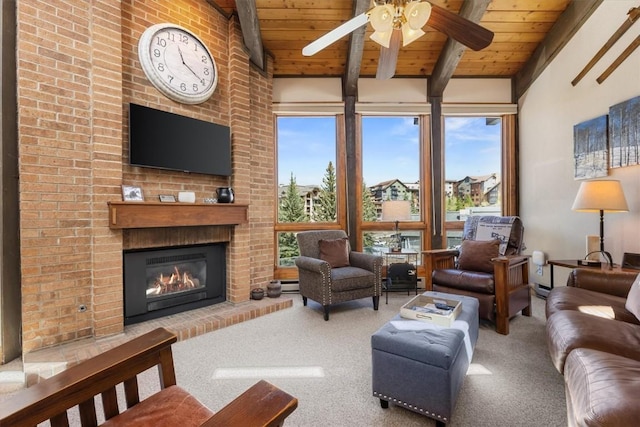2700 Village Dr Unit 301, Steamboat Springs, CO 80487 - carpeted living area featuring wood ceiling, a fireplace, a ceiling fan, and a baseboard radiator