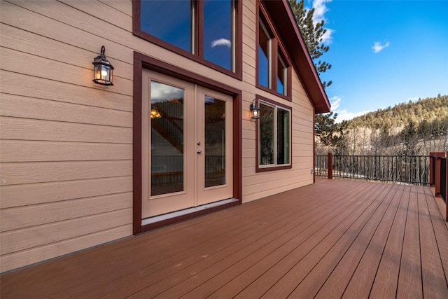 wooden deck with french doors and a mountain view